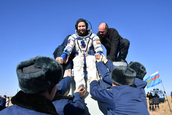 국제우주정거장(ISS)에서 12일간 장편 영화를 찍은 러시아의 감독과 배우 등 촬영팀이 17일(현지시간) 유인우주선을 타고 지구로 무사히 귀환했다. 러시아 관영 타스 통신 등에 따르면 이날 오전 영화감독인 클림 쉬펜코(38)와 여배우 율리야 페레실드(37), 우주인 올렉 노비츠키(50)를 태운 유인우주선 ‘소유스 MS-18’ 귀환 캡슐이 카자흐스탄의 초원지대에 안착했다. 캡슐에서 내린 여배우 페레실드가 환하게 웃고 있다.  [로이터]