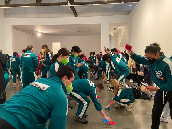 26일 맨해튼에서 한국관광공사(사장 안영배) 뉴욕지사가 기획한 ‘오징어 게임과 함께하는 뉴욕 속 한국여행’ 참가자들이 딱지치기 게임을 하고 있다.  [사진 한국관광공사 뉴욕지사]