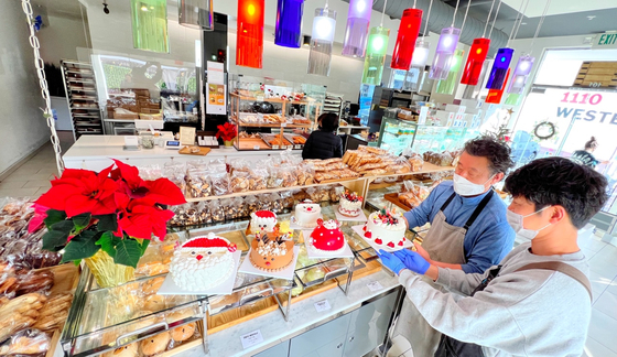 제빵업계 컨설팅 전문가인 이효상(왼쪽) 셰프가 직접 운영하는 코안도르 베이커리 앤 카페가 이번 주부터 본격적인 크리스마스 케이크 판매를 시작했다.  김상진 기자  