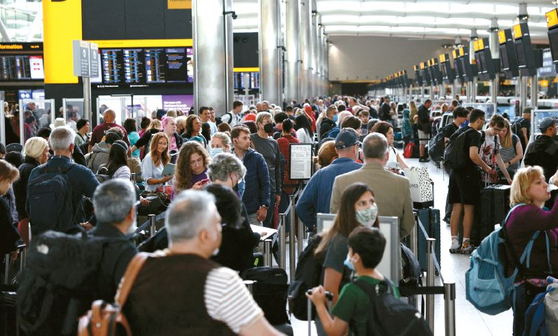 지난달 27일 영국 런던 히드로우 공항 출발 터미널 2에서 승객들이 줄을 서고 있다. [로이터]