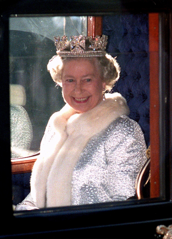 FILE PHOTO: Queen Elizabeth II smiles as she departs Buckingham Palace for the State Opening of Parliament ceremony at the Palace of Westminster, in London, Britain, November 15, 1995. Pool via REUTERS/File Photo