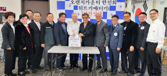 김용진(오른쪽에서 6번째) 회장을 비롯한 OC장로협의회 임원들이 한인회에 지진 성금을 내고 있다. 김 회장 왼쪽이 조봉남 한인회장. ［한인회 제공］