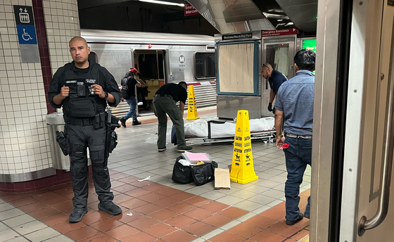 LA메트로에서 발생하는 범죄가 급증한 가운데 지난 11일 맥아더 파크 지하철역에서 검시국 직원들이 역내 벤치에서 발견한 사망자 시신을 수습하고 있다. [독자 데이비드 김 제공]