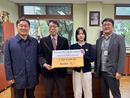 Minju Kang(Y12), an NLCS Jeju student, presents the donation to Sangman Lee, Principal of Daniel School for the disabled.