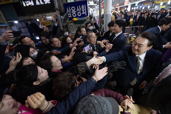 윤석열 대통령이 22일 경남 창원시 마산합포구 마산어시장을 찾아 시민들과 인사하고 있다. 이승환 기자