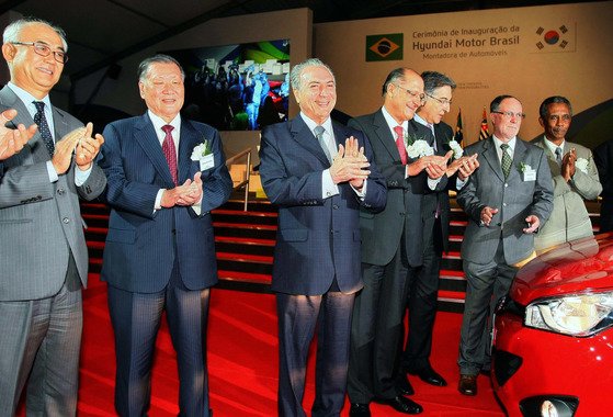 O presidente honorário do Hyundai Motor Group, Chung Mong-koo (segundo a partir da esquerda), posa em frente ao HB20 fabricado na cerimônia de encerramento da fábrica da Hyundai Motor Company no Brasil em 2012.  Foto do Hyundai Motor Group