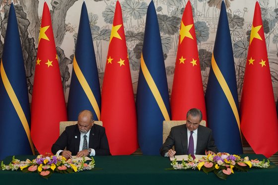리오넬 아인기미 나우루 외교장관(왼쪽)과 왕이 중국 외교부장이 1월 24일 베이징 댜오위타이 국빈관에서 중·나우루 수교 재개에 관한 공동성명에 서명하고 있다. 이로써 현재 중국과 국교를 수립한 국가는 183곳이 됐다. AFP=연합뉴스