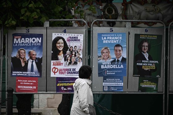 지난 4월 한 여성이 프랑스 남서부 레섬의 아르상레에서 6월 9일 유럽의회 선거에 출마할 프랑스 후보들의 캠페인 포스터를 살펴보고 있다. AFP=연합뉴스