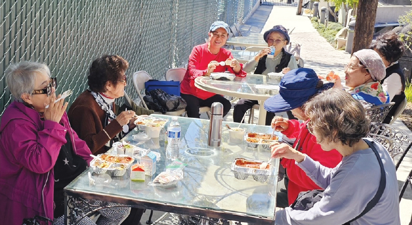 한인 시니어들이 시니어센터에서 제공하는 무료 도시락으로 점심 식사를 하고 있다.