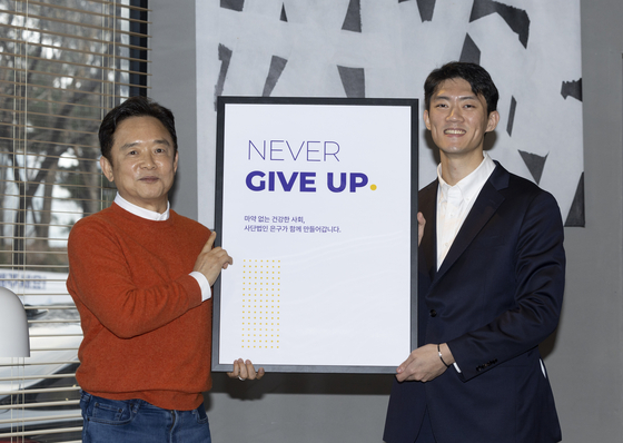 남경필 대표가 전우원씨와 함께 단체명의 기원인 ‘NEVER GIVE UP’(절대 포기하지 마라)이 쓰인 패널을 들어 보이고 있다. 김상선 기자