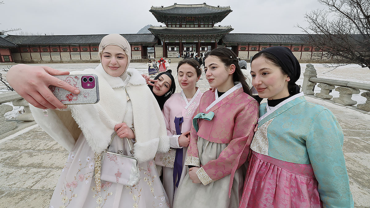 설 연휴인 28일 한복을 입고 서울 경복궁을 찾은 외국인 관광객이 기념사진을 찍고 있다. 뉴스1