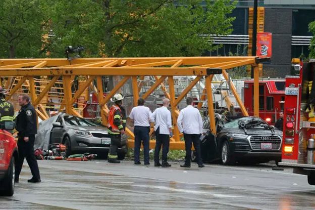 First responders at the scene evaluate the situation. [Source: Associated Press, Alan Berner]