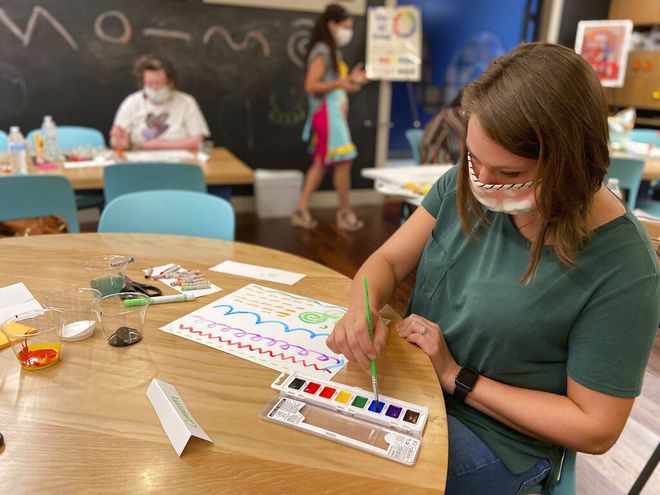 Teacher Cameron McMillan creates a painting during a visual arts workshop at the Mississippi Arts + Entertainment Experience in Meridian, Miss. on Monday, July 13, 2020. Teachers will return to school in August under new guidelines to prevent the spread of COVID-19. (Bill Graham/The Meridian Star via AP)