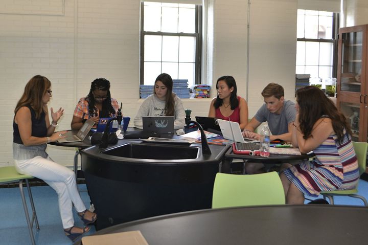 Students enrolled in an IB program, working with an instructor on their current curriculum. [Source: Isabelle Chicoine/French-American School of New York via AP]