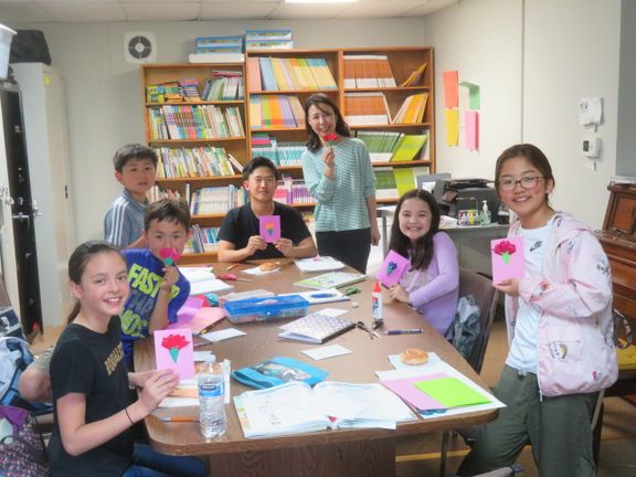 아리랑반 학생들이 김지혜 교장과 함께 만든 카드를 들고 포즈를 취하고 있다.