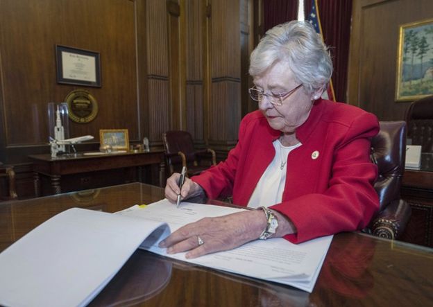 Alabama Governor Kay Ivey signs an abortion ban into law.  Source: Associated Press, Hal Yeager