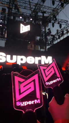 Lightsticks with the SuperM logo were handed out before the performance began.