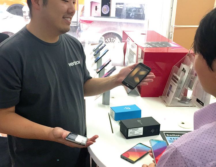 LA한인타운에 있는 휴대폰 판매 업소 관계자가 고객에게 가격 등에 대해 설명하고 있다. [중앙포토]