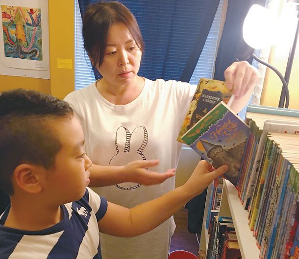 배소희씨가 아들 로이 김(3가초교 4학년)군이 책을 고르는 걸 도와주고 있다.