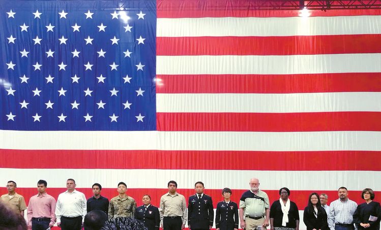 LA컨벤션센터에서 열린 시민권자 선서식에서 영주권자들이 미국을 상징하는 대형 성조기를 배경으로 선서식을 하고 있는 모습. 박낙희 기자