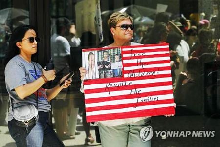 13일 시카고에서 열린 이민자 단속 항의집회에서 한 참가자가 '아이들을 석방하라'는 표지판을 들고 있다. [AFP=연합뉴스]
