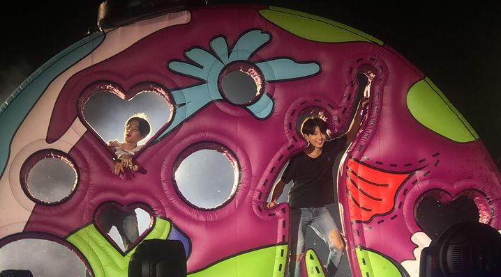 Two of the members, Jimin (left) and Jungkook (right), posed with their song Anpanman’s stage set. [Source: Author, Sungmin Stella Kim] 